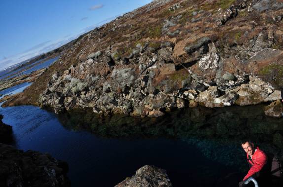 Feliz, admirando a fenda que divide dois continentes: América e Europa, no Parque Nacional Thingvellir, na Islândia